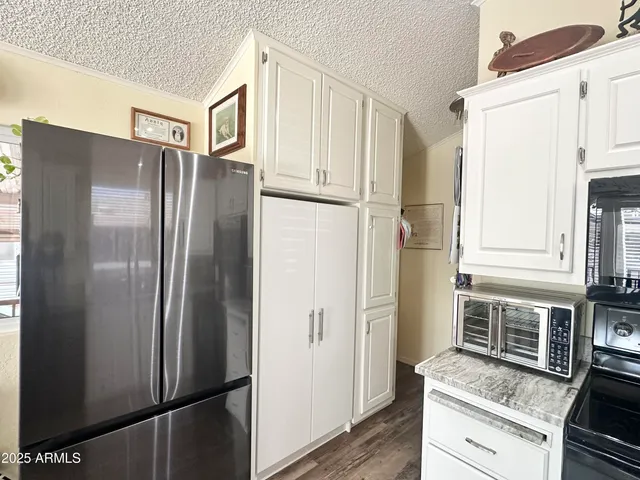 a bedroom with a large bed and wooden floor