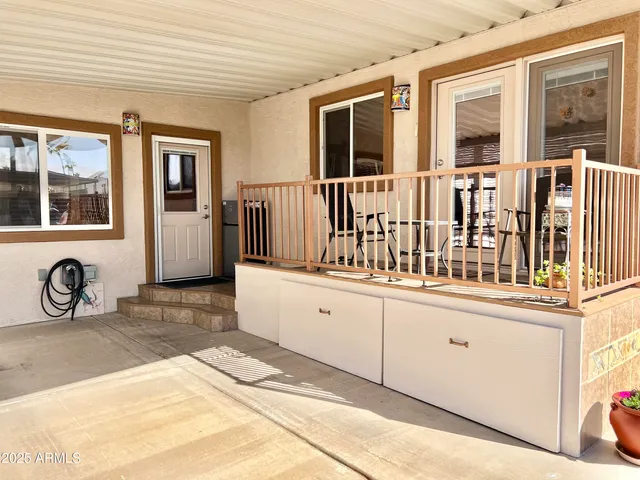 a living room with furniture a large window and a fireplace