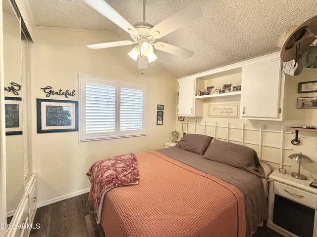 a front view of a house with a yard and tree s