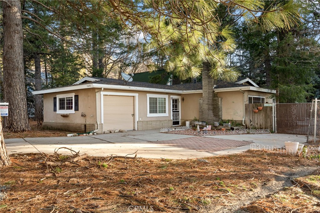 26473 Apache Trail Rimforest, CA 92378 - Photo 1 of 1 a view of a yard with a table and chairs under an umbrella