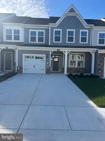 a view of a brick house with a yard