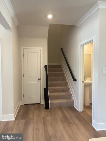 a view of a hallway with wooden floor and entryway