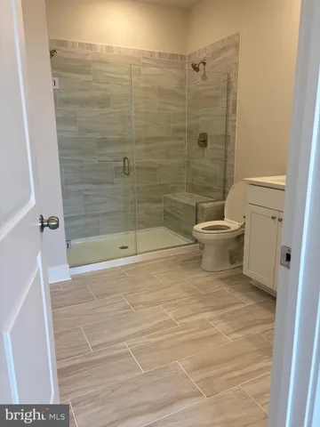 a bathroom with a shower and a toilet