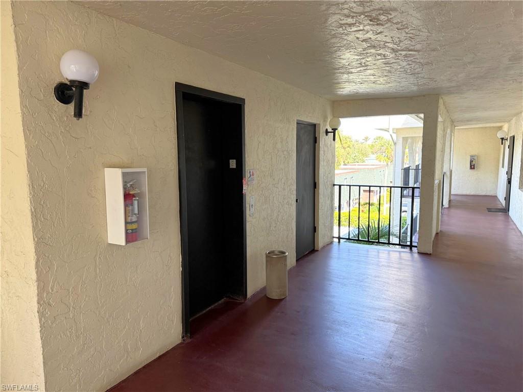 700 Valley Stream Drive, Unit 303 Naples, FL 34113 - Photo 6 of 9 wooden floor in an empty room with a window