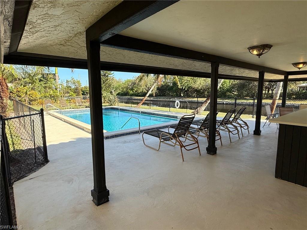700 Valley Stream Drive, Unit 303 Naples, FL 34113 - Photo 7 of 9 a view of a room with lots of table and chairs