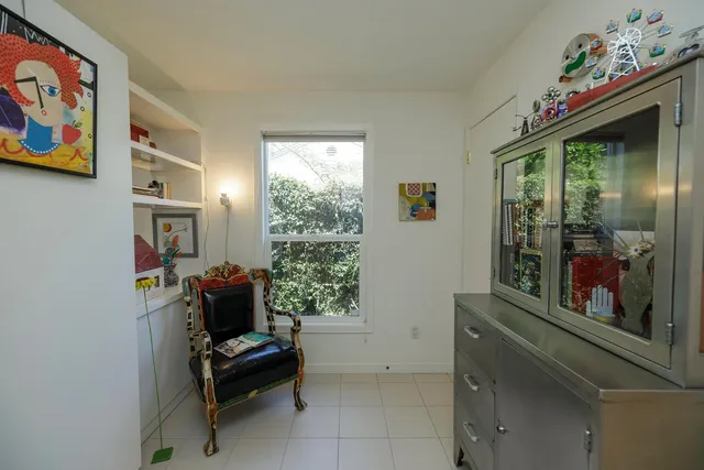 a view of a workspace with furniture and a fireplace