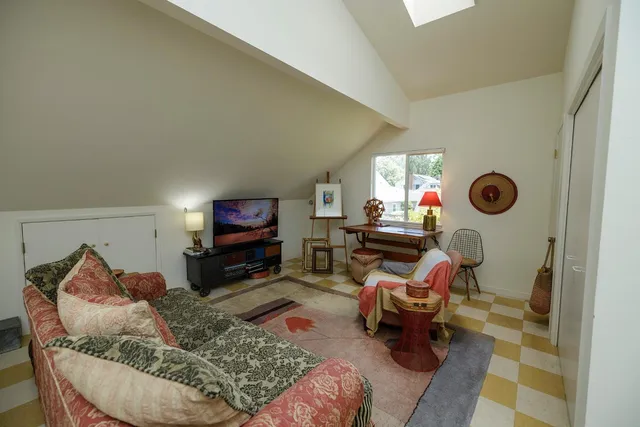 a living room with furniture rug and a window
