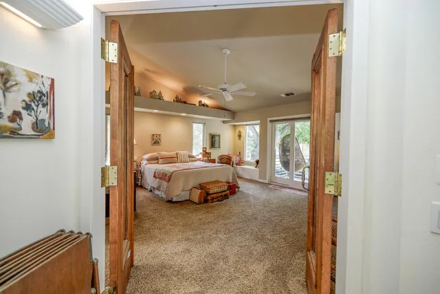 a bedroom with furniture and a large mirror