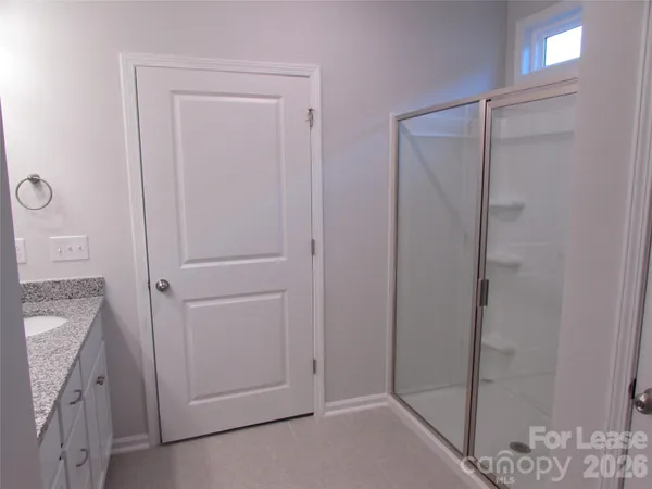a bathroom with a shower and a sink