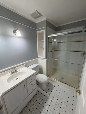 a bathroom with a sink toilet and shower