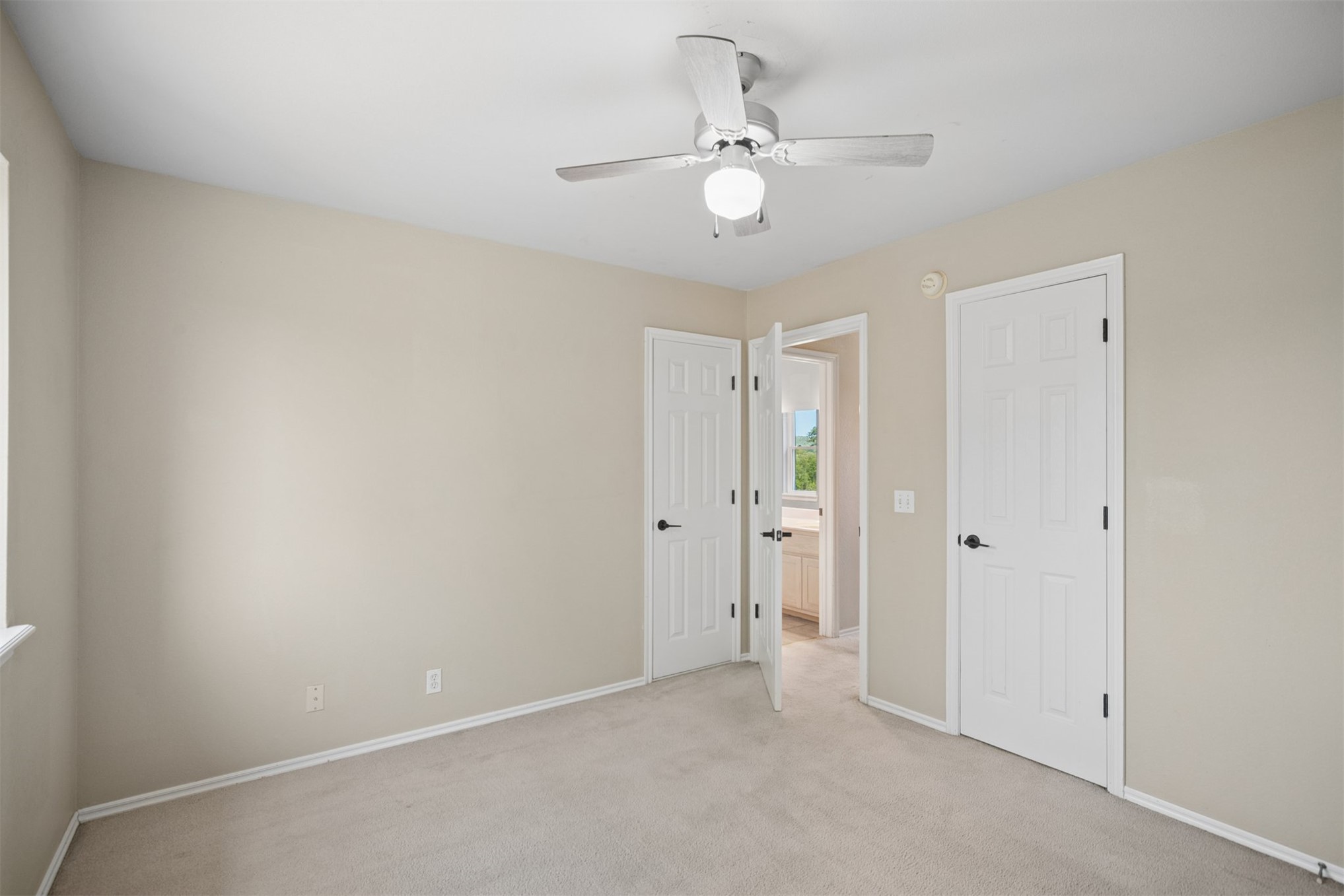 175 Alt 75 Mounds, OK 74047 - Photo 35 of 41 Wall-to-wall carpeting, ceiling fan with integrated lighting, and white paneled doors with matte black hardware