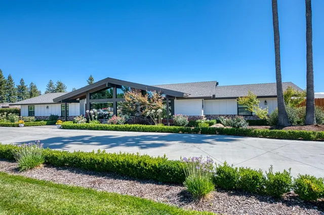 a front view of house with yard and green space