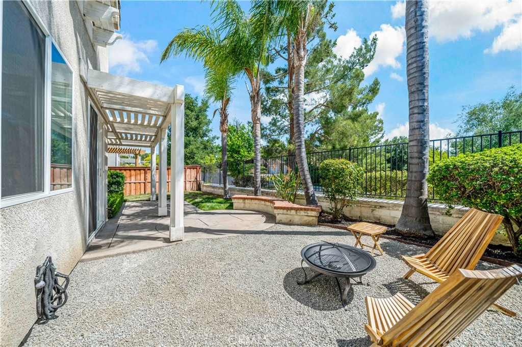 33307 Decada Street Temecula, CA 92592 - Photo 22 of 35 a view of a patio with couches table and chairs and potted plants