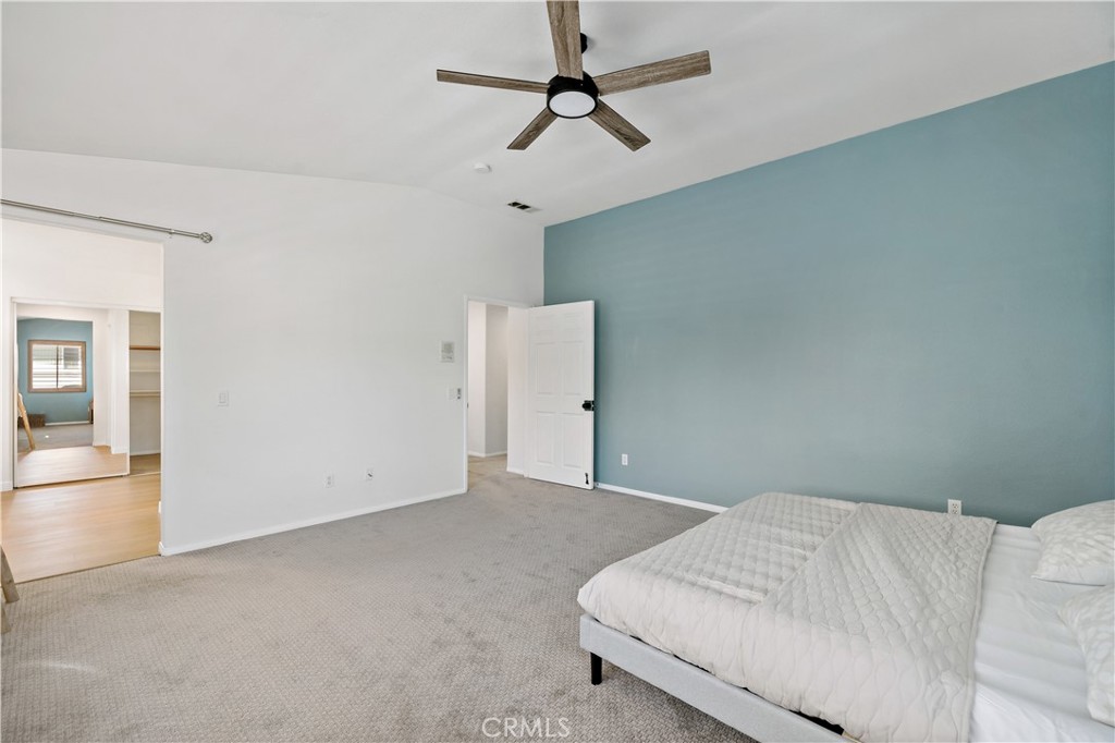 33307 Decada Street Temecula, CA 92592 - Photo 25 of 35 a bedroom with a bed and chandelier fan