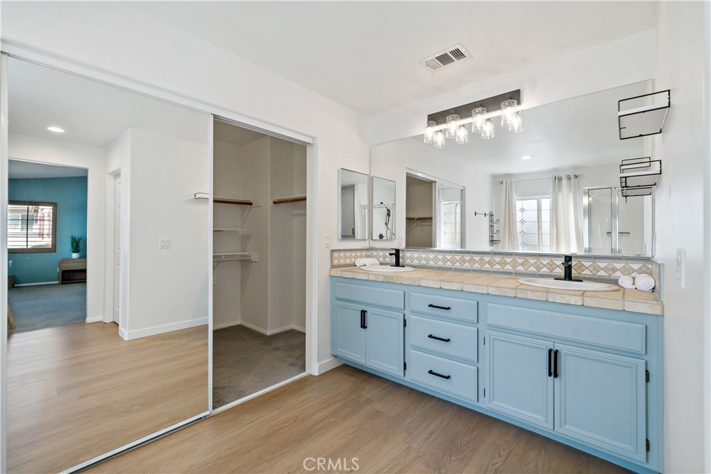 33307 Decada Street Temecula, CA 92592 - Photo 27 of 35 a spacious bathroom with a granite countertop sink mirror and shower