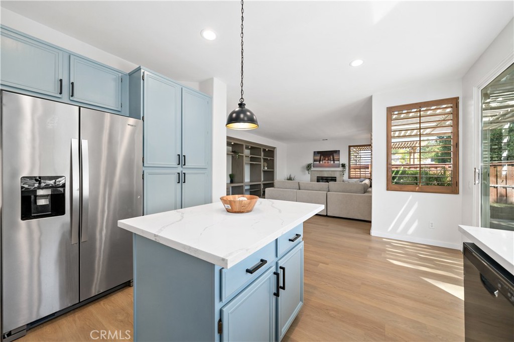 33307 Decada Street Temecula, CA 92592 - Photo 4 of 35 a kitchen with refrigerator cabinets and wooden floor