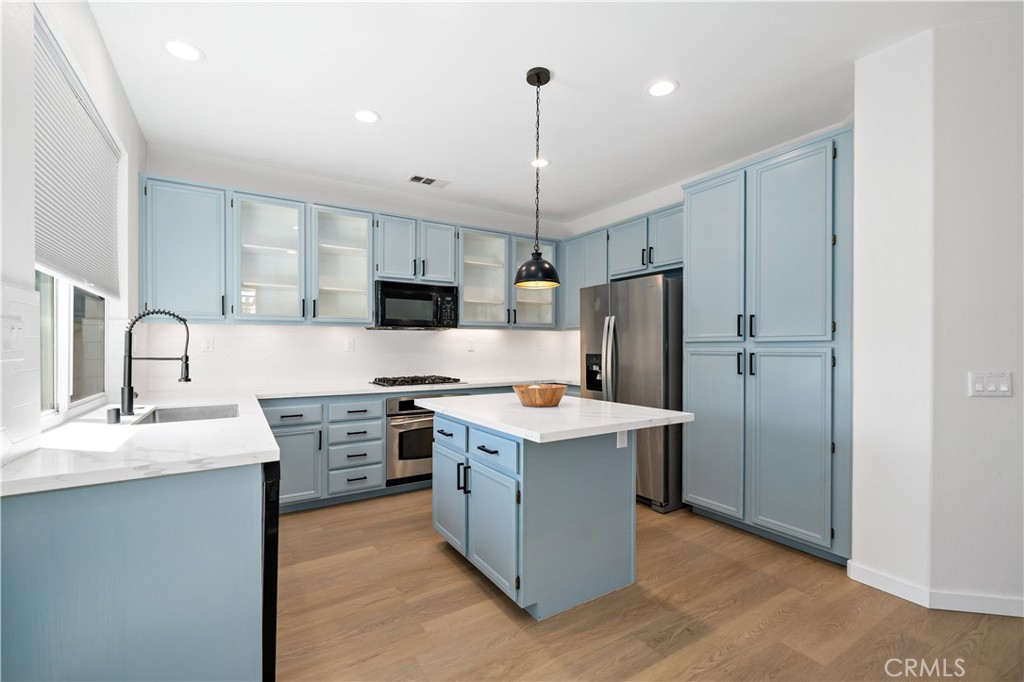 33307 Decada Street Temecula, CA 92592 - Photo 6 of 35 a kitchen with stainless steel appliances granite countertop a refrigerator a sink dishwasher a stove and a refrigerator