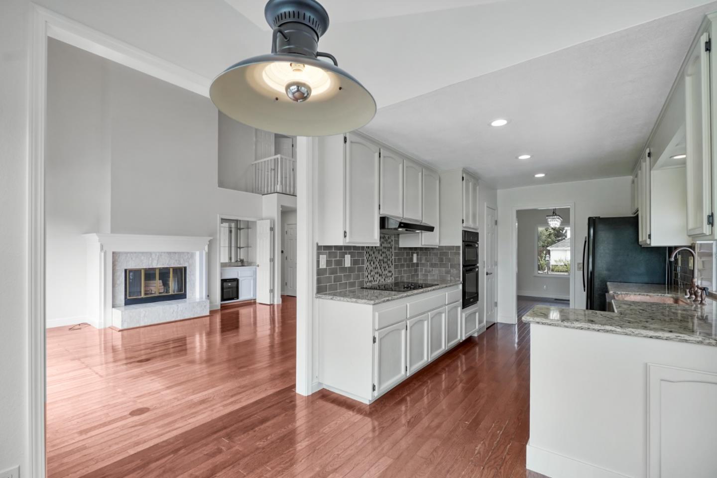 190 Cypress Point Road Half Moon Bay, CA 94019 - Photo 16 of 55 a large kitchen with stainless steel appliances granite countertop a lot of counter space and wooden floor