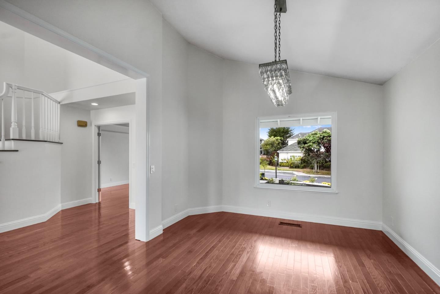 190 Cypress Point Road Half Moon Bay, CA 94019 - Photo 19 of 55 a view of an empty room with wooden floor and a window
