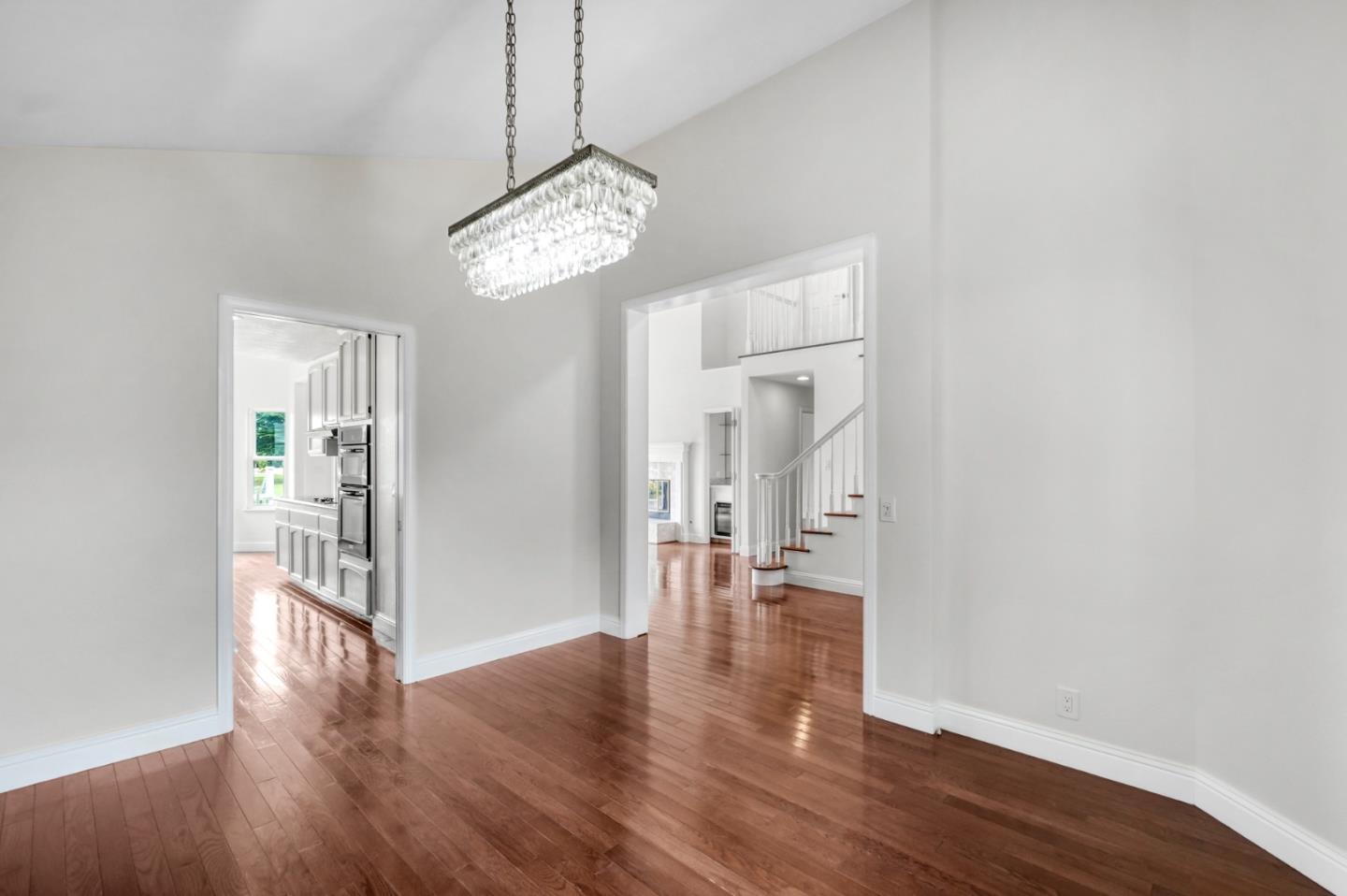 190 Cypress Point Road Half Moon Bay, CA 94019 - Photo 20 of 55 a view of a hallway with wooden floor and a chandelier