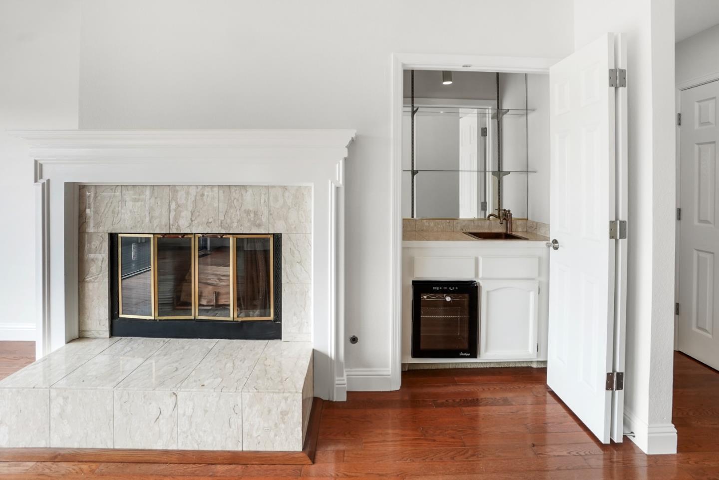 190 Cypress Point Road Half Moon Bay, CA 94019 - Photo 21 of 55 a view of an empty room with wooden floor and a fireplace