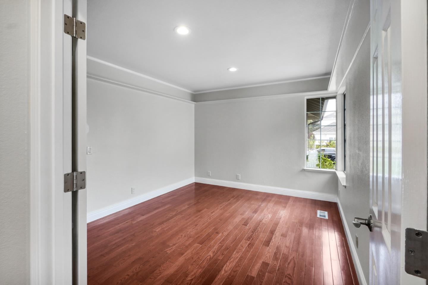 190 Cypress Point Road Half Moon Bay, CA 94019 - Photo 22 of 55 an empty room with wooden floor and windows