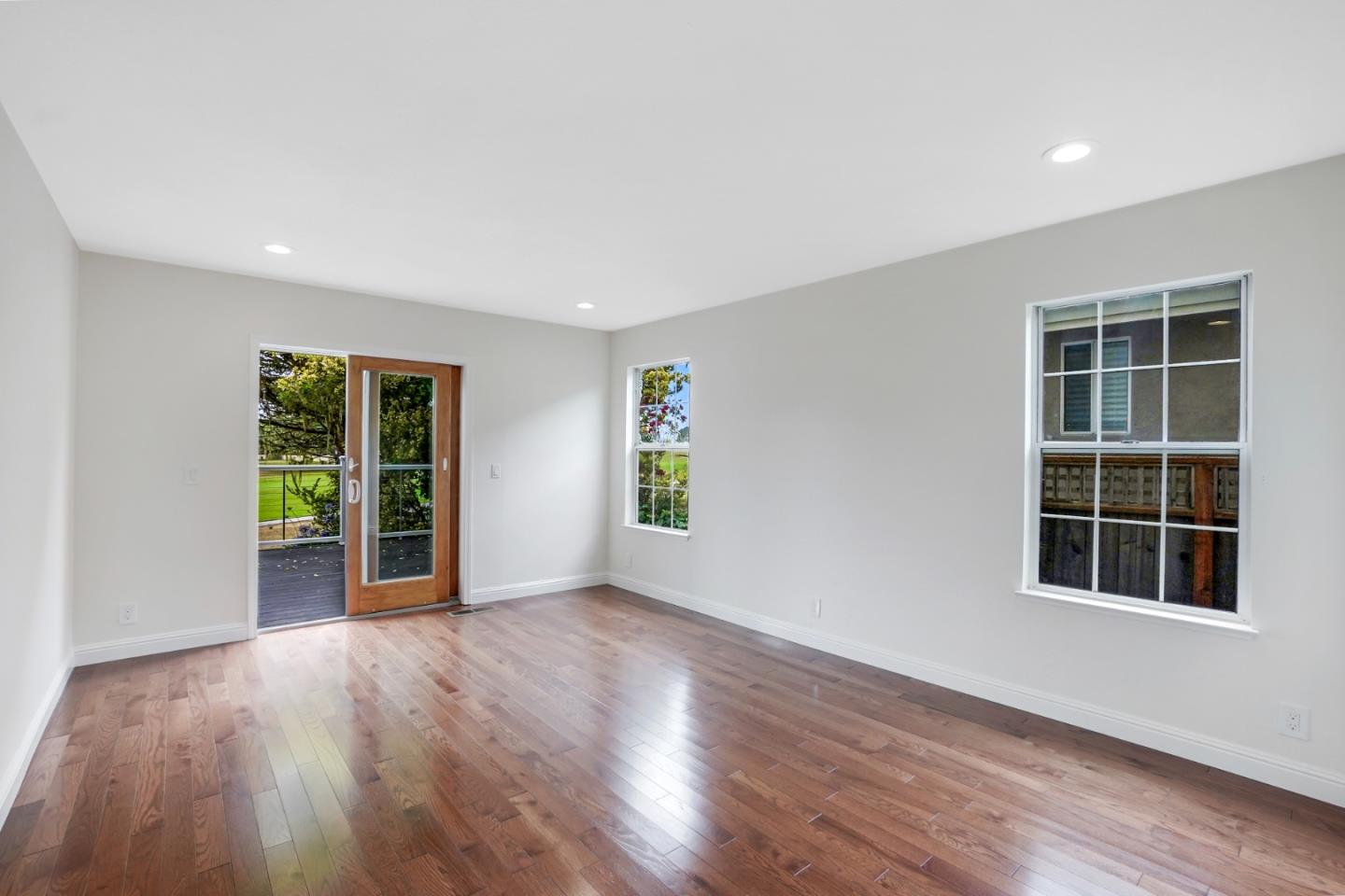 190 Cypress Point Road Half Moon Bay, CA 94019 - Photo 27 of 55 a view of an empty room with wooden floor and windows