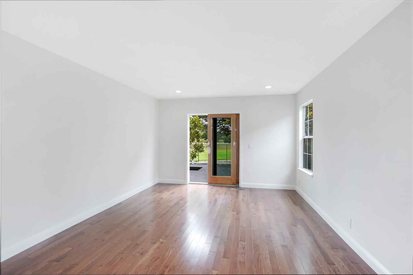 190 Cypress Point Road Half Moon Bay, CA 94019 - Photo 28 of 55 an empty room with wooden floor and windows