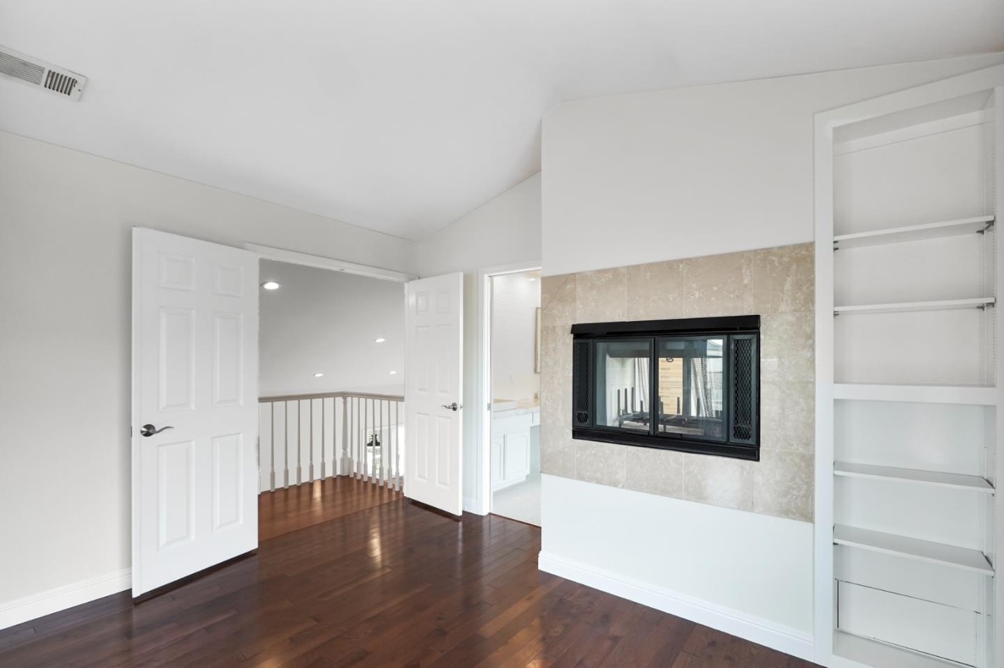 190 Cypress Point Road Half Moon Bay, CA 94019 - Photo 41 of 55 an empty room with wooden floor a fireplace and windows