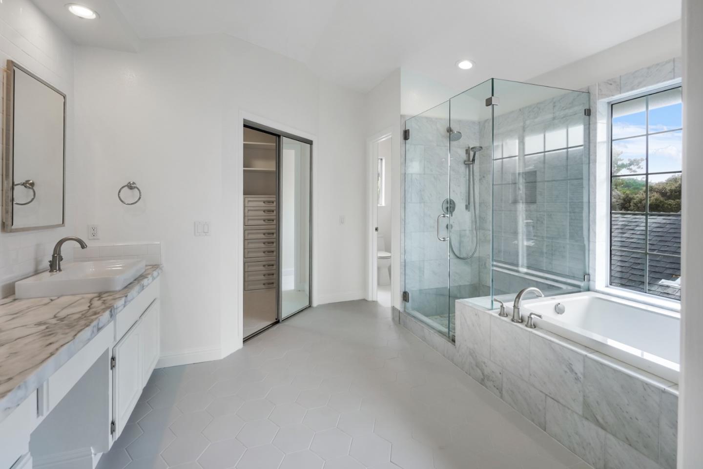 190 Cypress Point Road Half Moon Bay, CA 94019 - Photo 42 of 55 a spacious bathroom with a granite countertop tub sink a shower and a mirror