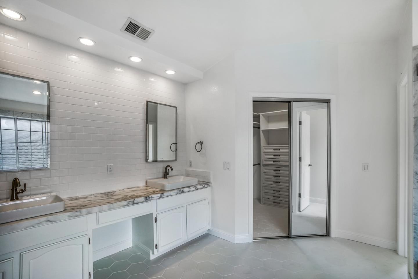 190 Cypress Point Road Half Moon Bay, CA 94019 - Photo 43 of 55 a spacious bathroom with a granite countertop sink a toilet a mirror and shower