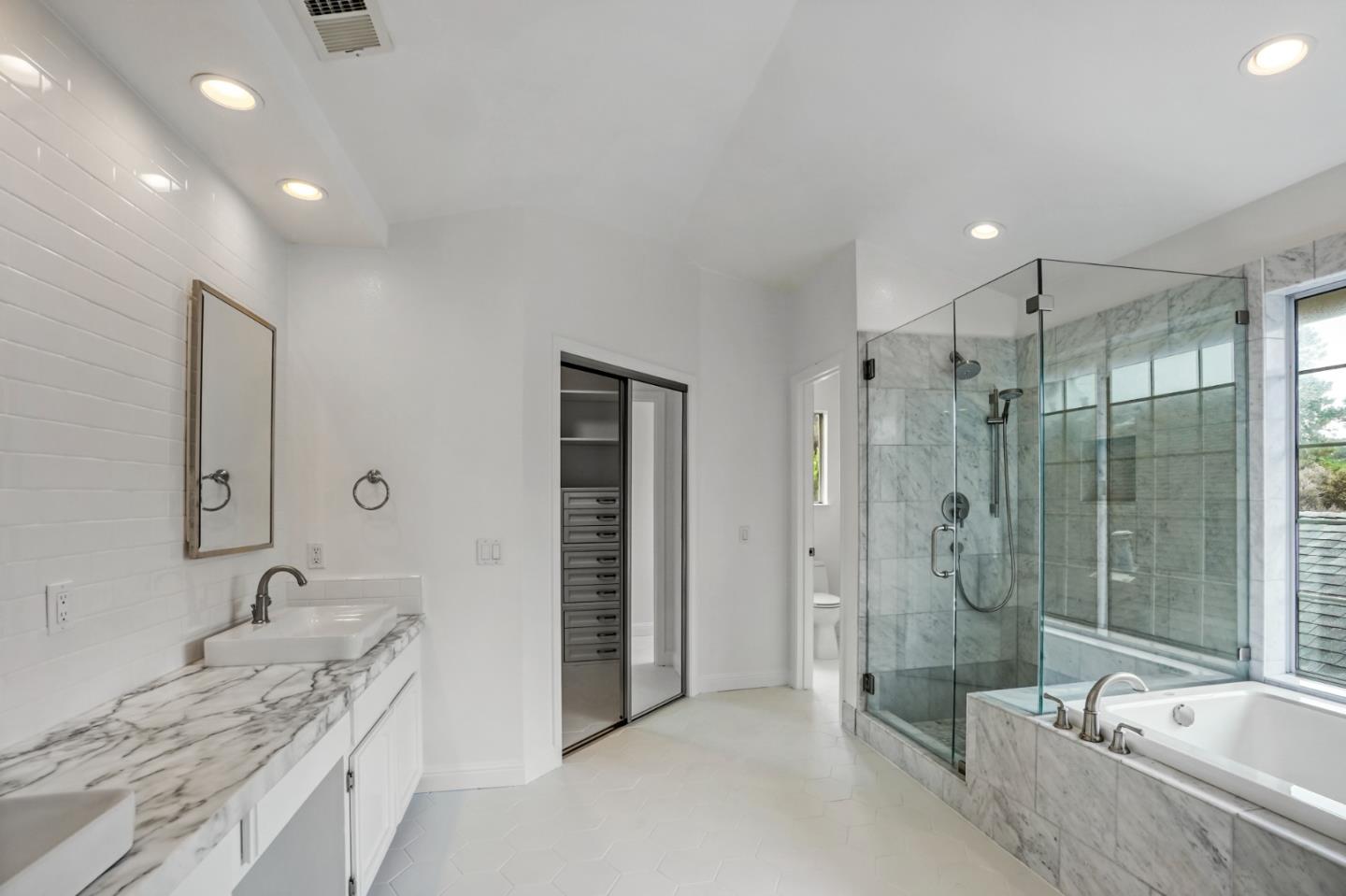 190 Cypress Point Road Half Moon Bay, CA 94019 - Photo 44 of 55 a bathroom with a granite countertop tub sink shower and mirror
