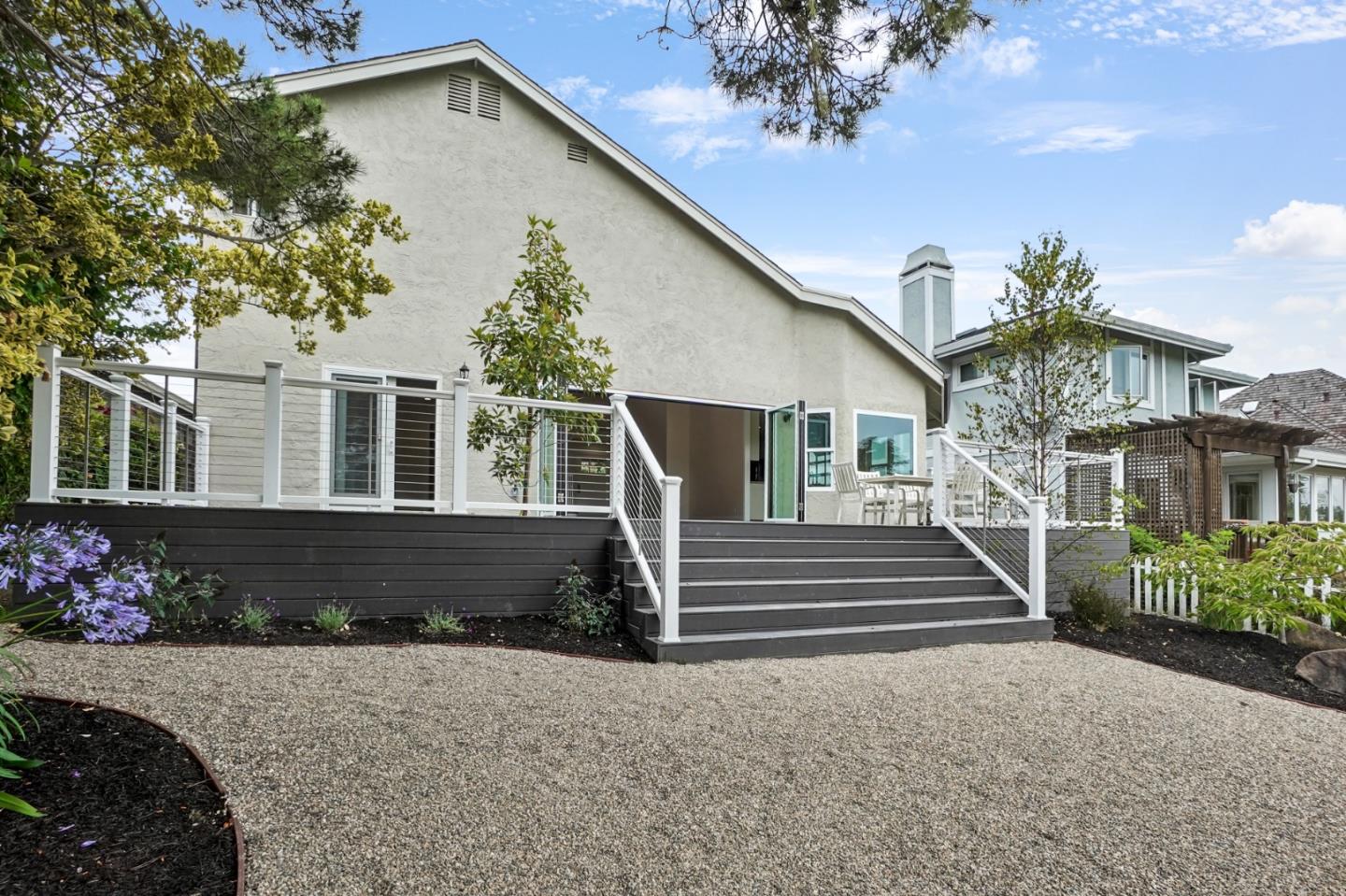 190 Cypress Point Road Half Moon Bay, CA 94019 - Photo 9 of 55 a front view of a house with a garden