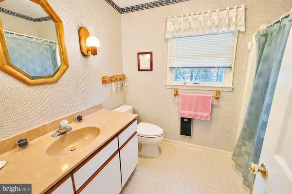 a bedroom with a bed a couch and a large window