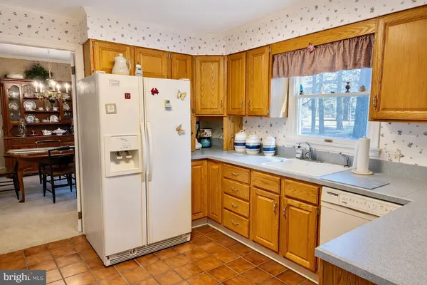 a white refrigerator freezer sitting inside of a kitchen