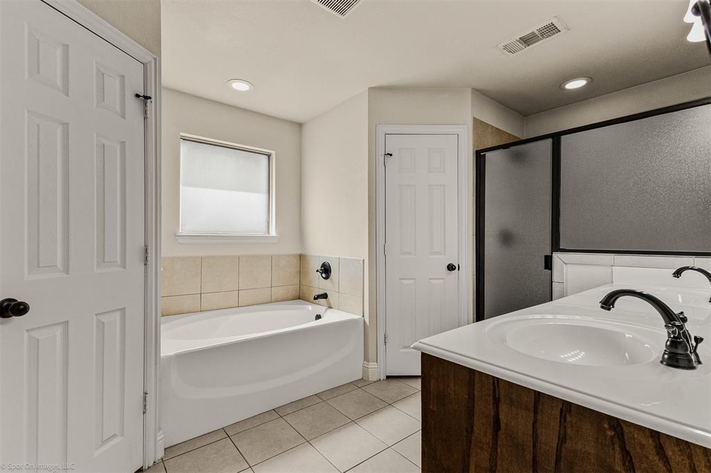 144 Birdsong Lane Terrell, TX 75160 - Photo 16 of 28 a bathroom with a sink and a mirror