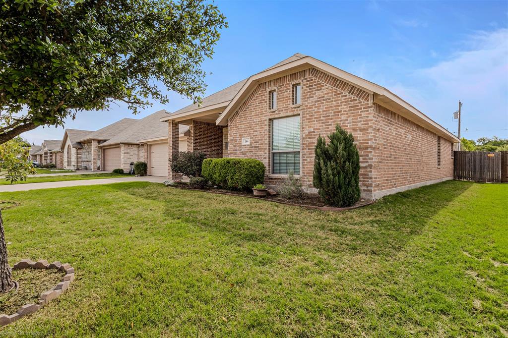 144 Birdsong Lane Terrell, TX 75160 - Photo 2 of 28 a front view of a house with a garden