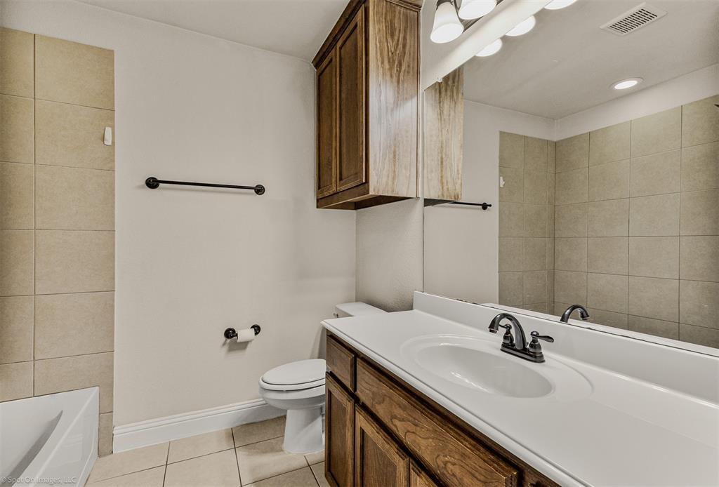 144 Birdsong Lane Terrell, TX 75160 - Photo 21 of 28 a bathroom with a sink a toilet and shower