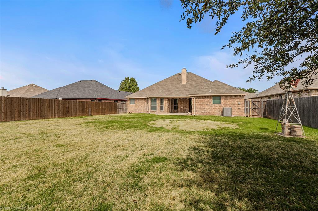 144 Birdsong Lane Terrell, TX 75160 - Photo 27 of 28 a front view of a house with a yard