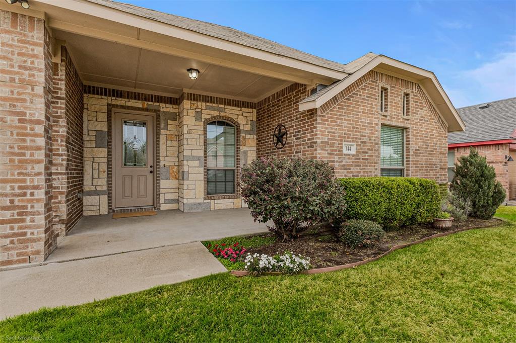 144 Birdsong Lane Terrell, TX 75160 - Photo 3 of 28 a front view of a house with a yard