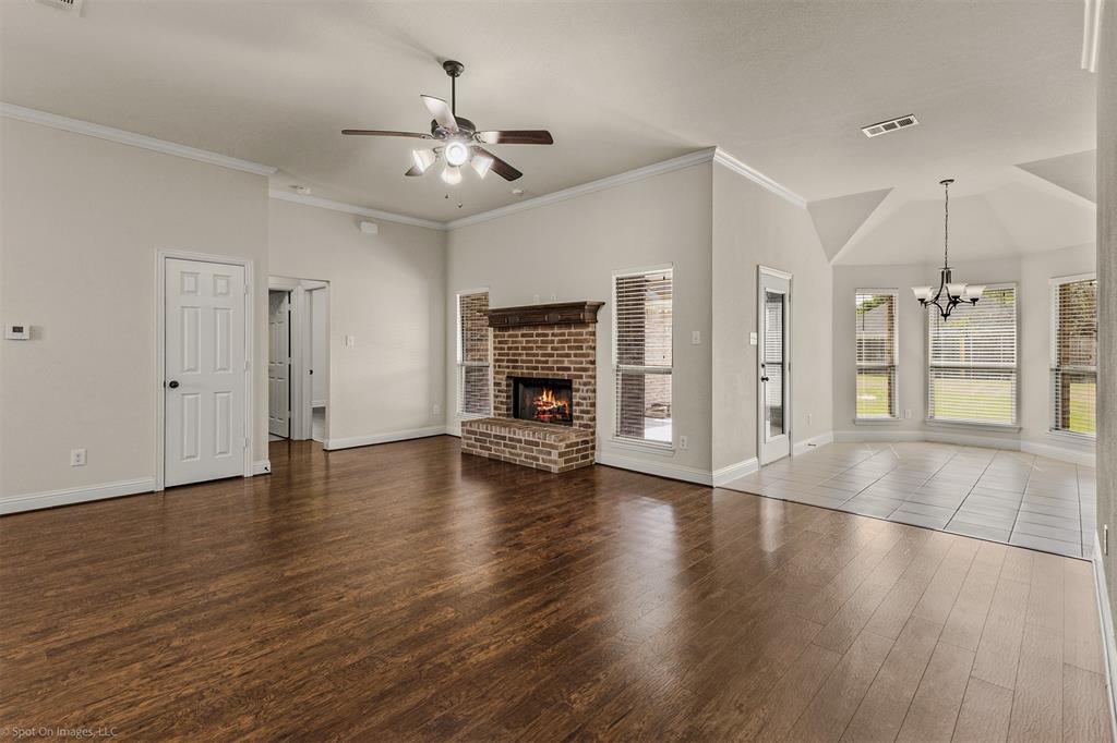 144 Birdsong Lane Terrell, TX 75160 - Photo 7 of 28 a view of an empty room with wooden floor fireplace and a window