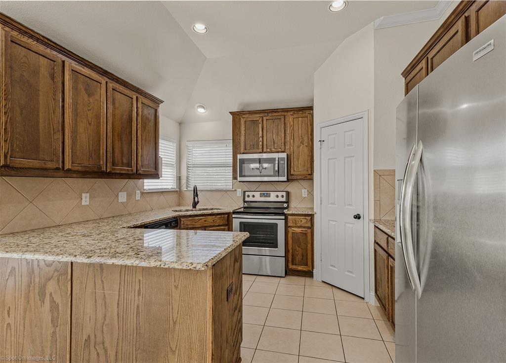 144 Birdsong Lane Terrell, TX 75160 - Photo 9 of 28 a kitchen with stainless steel appliances granite countertop a refrigerator and a sink