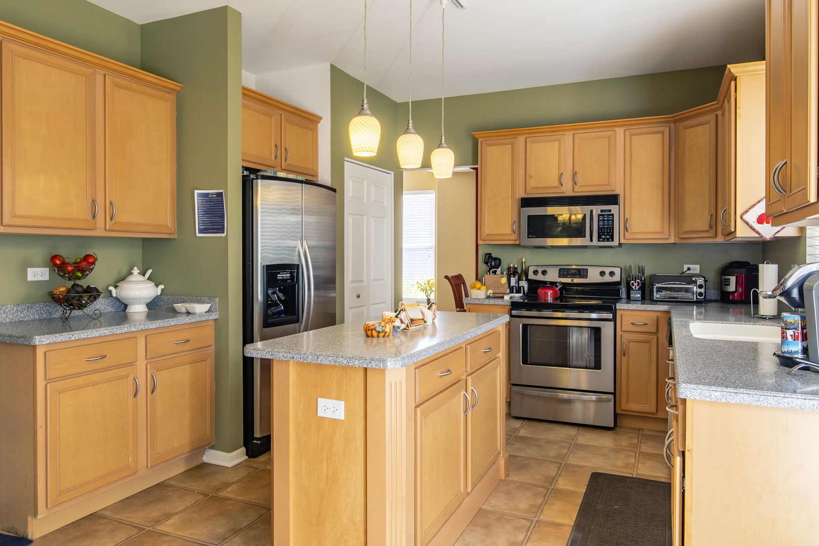 768 North Overlook Trail Round Lake, IL 60073 - Photo 13 of 34 a kitchen with stainless steel appliances a stove a sink a refrigerator white cabinets and a microwave