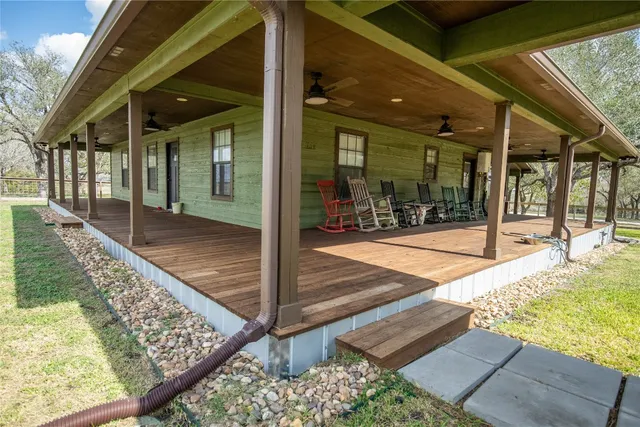 a outdoor living space with furniture and a flat screen tv