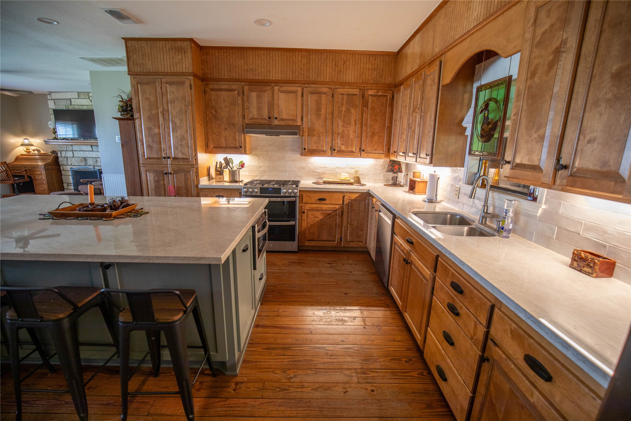698 Hilbrich Road Westhoff, TX 77994 - Photo 25 of 40 a kitchen with stainless steel appliances a sink stove and wooden cabinets
