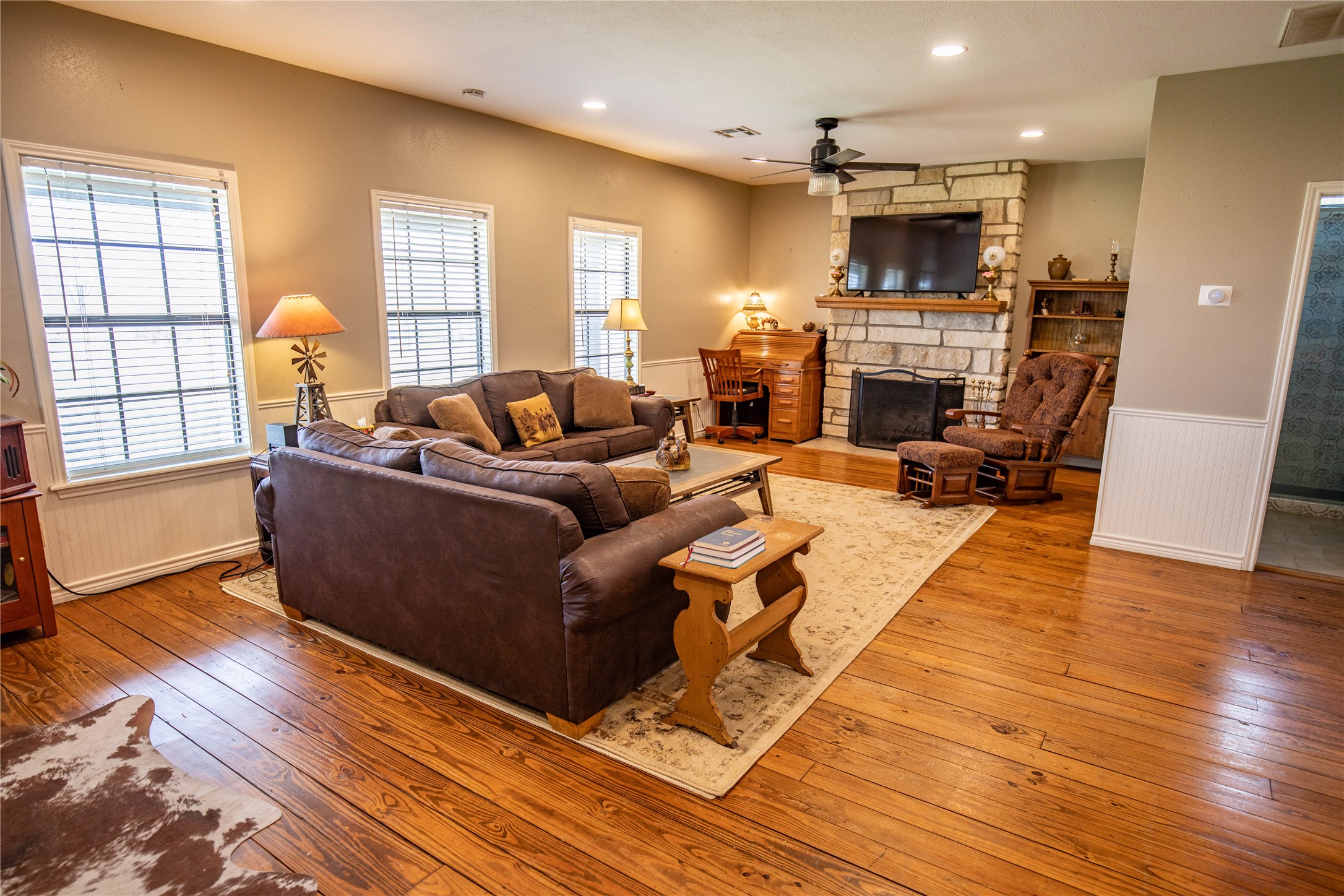 698 Hilbrich Road Westhoff, TX 77994 - Photo 26 of 40 a living room with furniture a fireplace and a flat screen tv