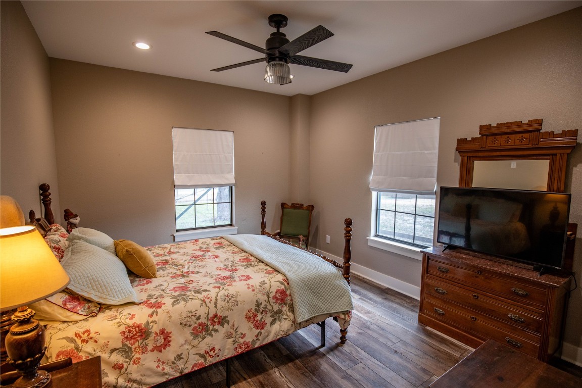 698 Hilbrich Road Westhoff, TX 77994 - Photo 38 of 40 a bedroom with a bed and wooden floor