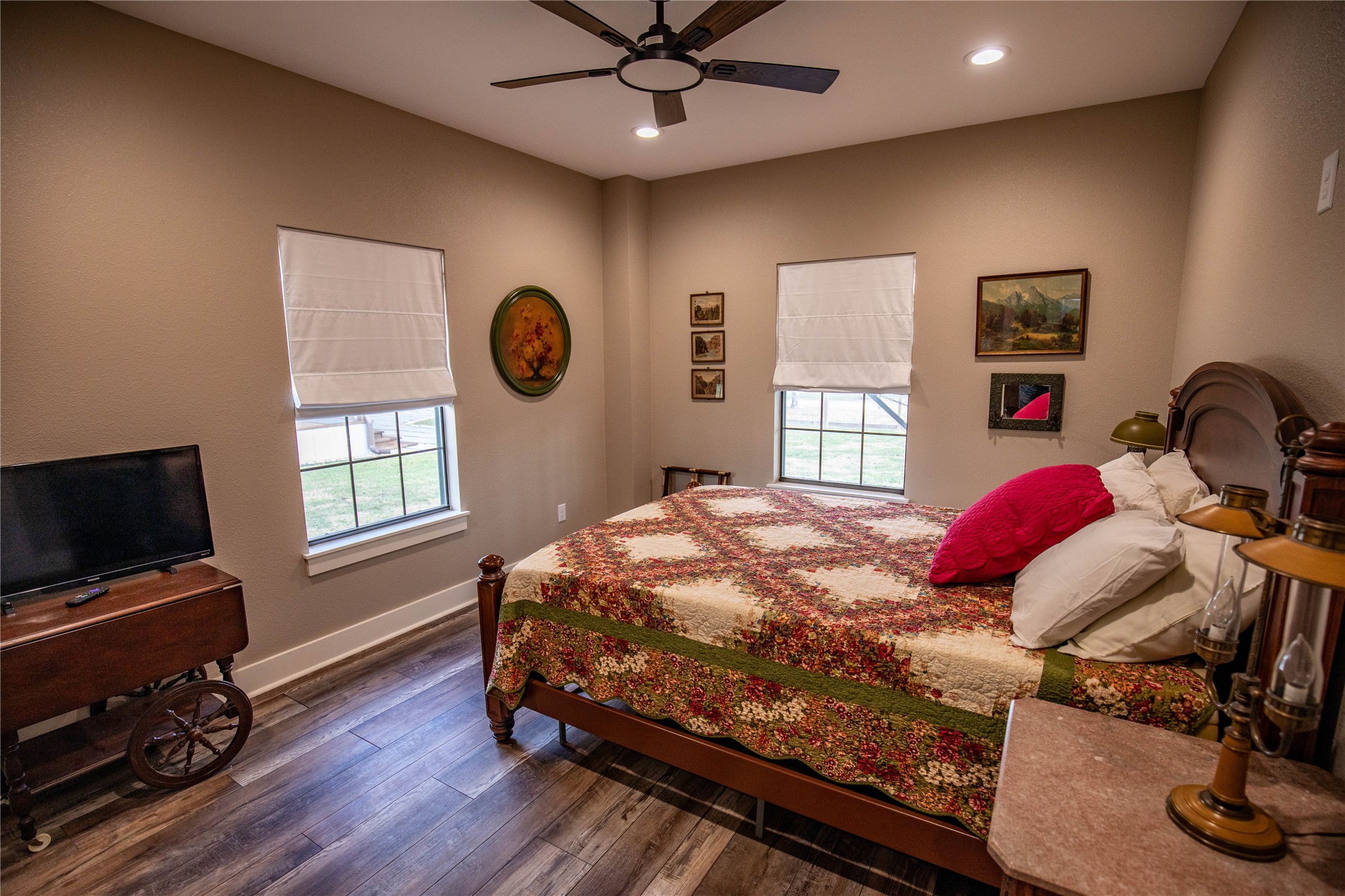 698 Hilbrich Road Westhoff, TX 77994 - Photo 39 of 40 a bedroom with a bed and dresser with wooden floor