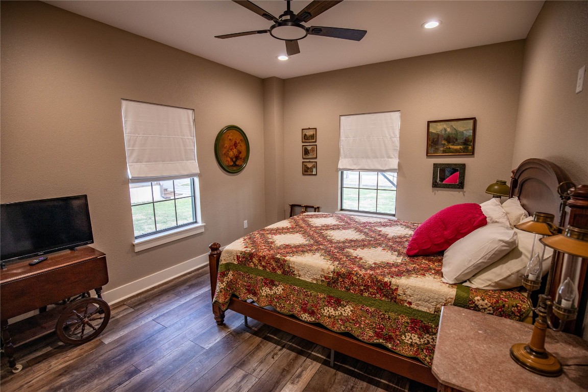 698 Hilbrich Road Westhoff, TX 77994 - Photo 39 of 40 a bedroom with a bed and dresser with wooden floor