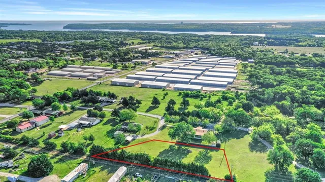 a view of swimming pool with outdoor seating and trees in the background